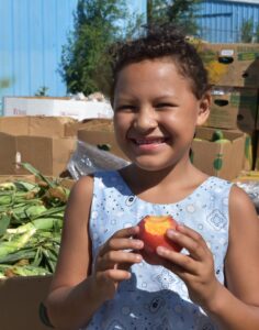 Indigenous Youth RFP - Girl holding a peach