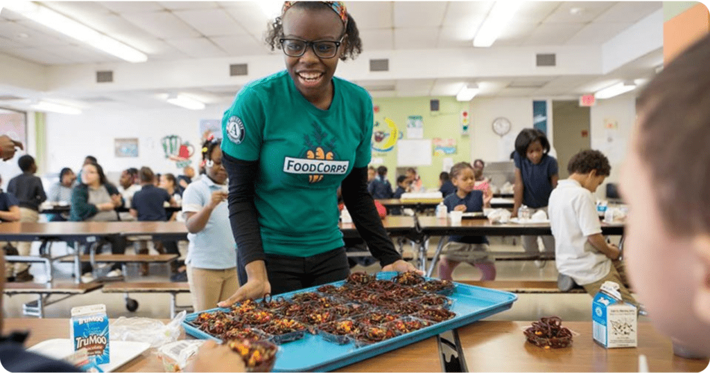 FoodCorps service member in the cafeteria with kids