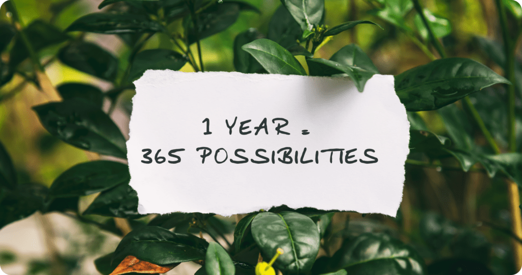 "1 year. 365 possibilities." on a background of greenery