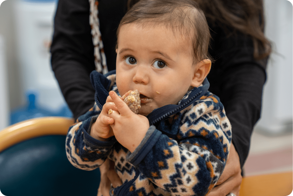 CIMCC - toddler eating Acorn Bites