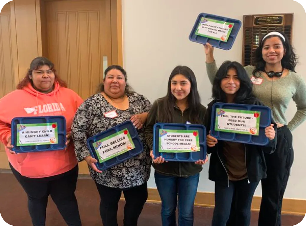 Youth standing with lunch trays.