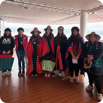 Youth stand in traditional garments.