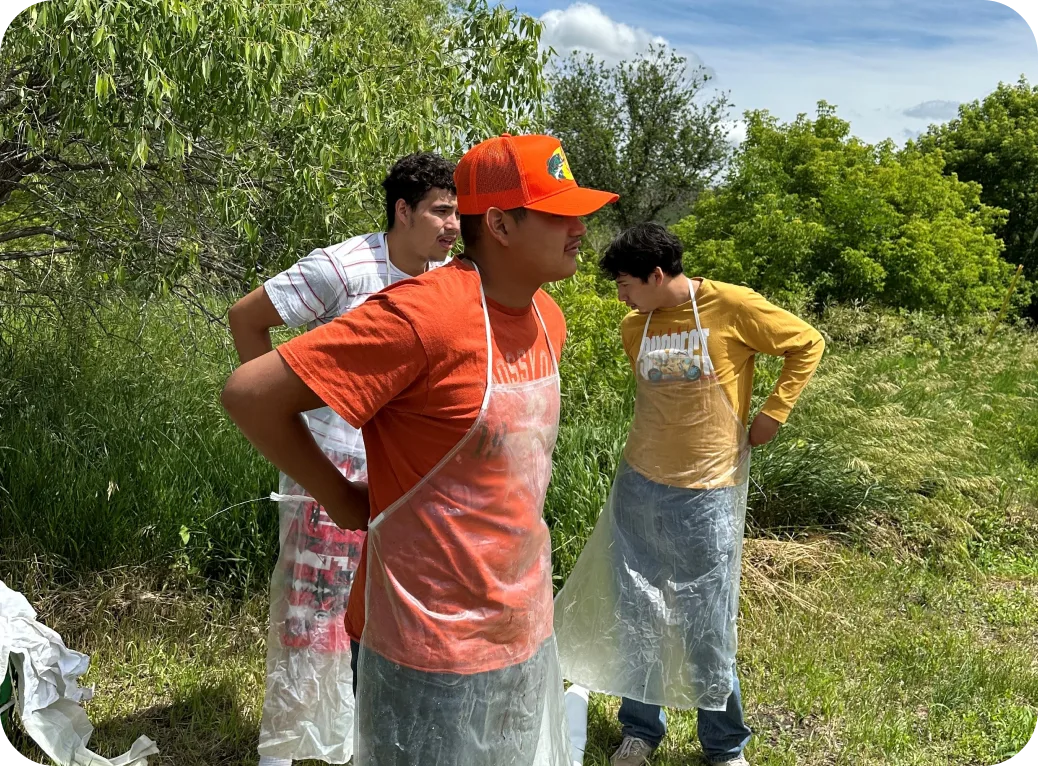 Youth put on clear aprons.