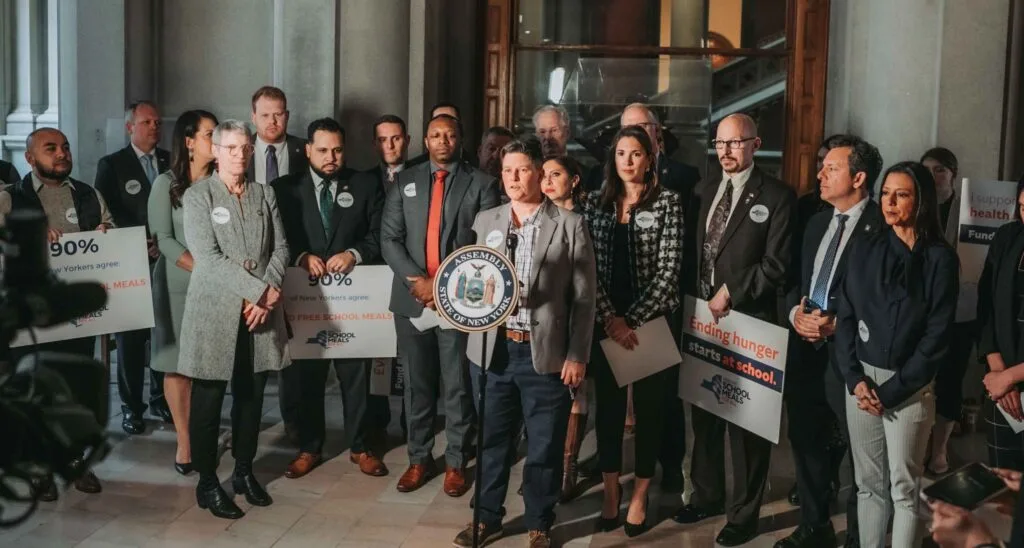 Liz speaking at a podium.