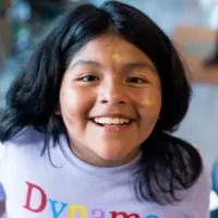 A young camper with glitter face paint