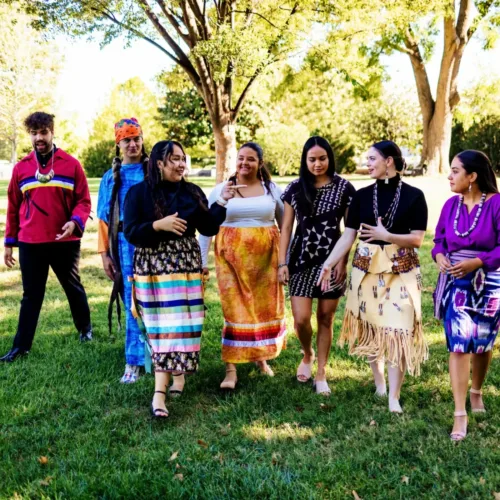 A group of young people in colorful traditional clothes