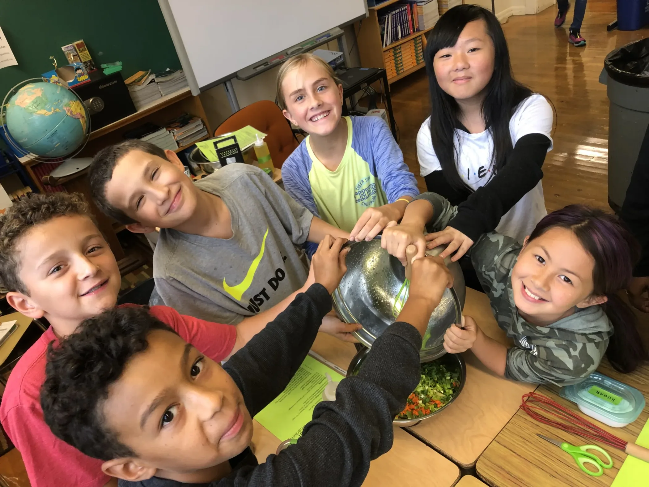 Kids stand with hands in a circle