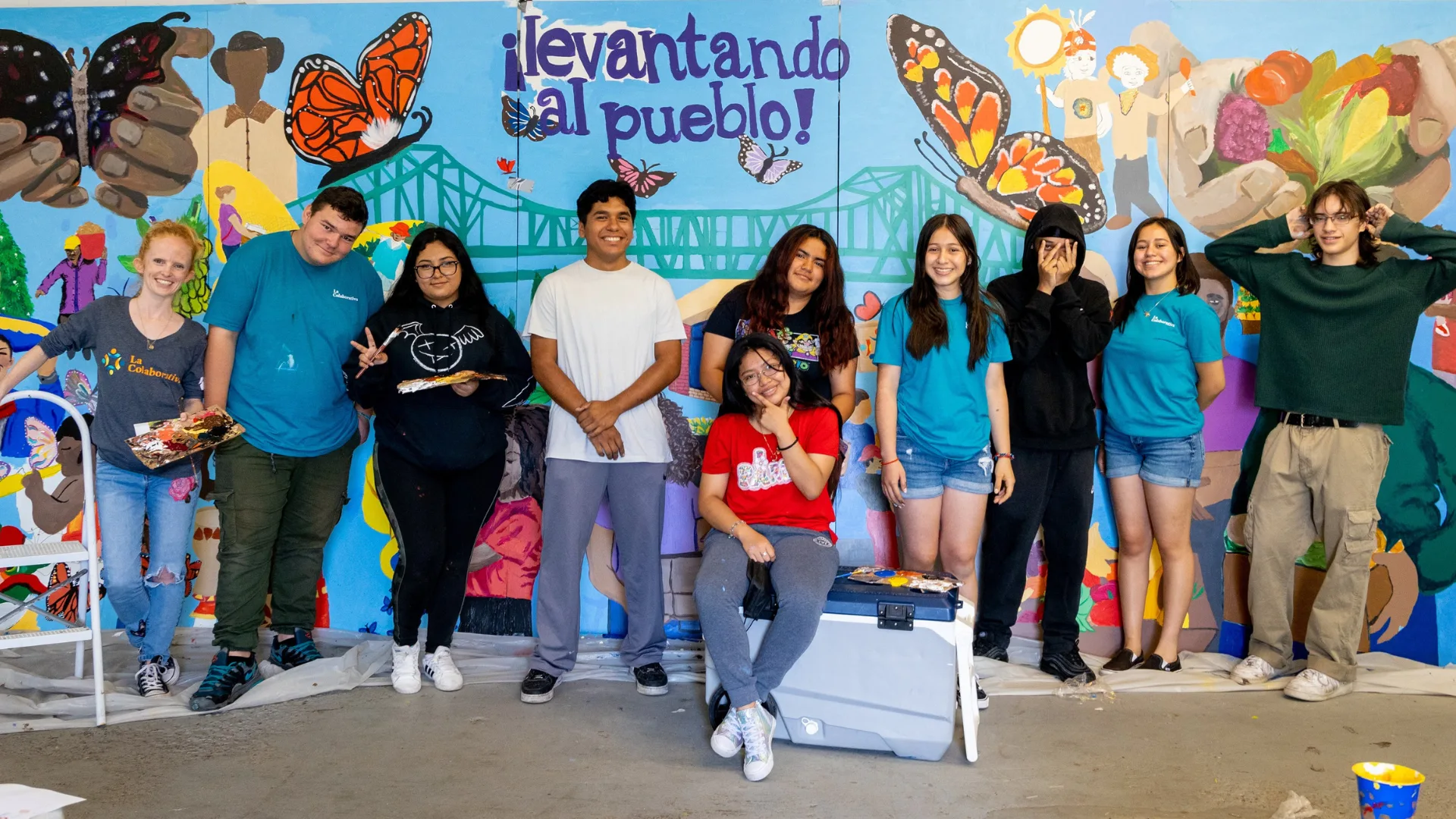 Youth in front of a mural